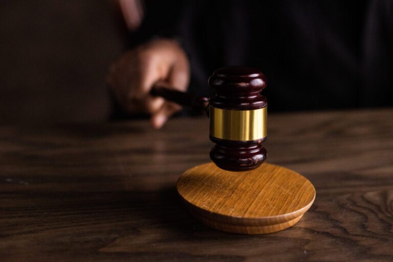 Auction Gavel slamming into wooden desk.