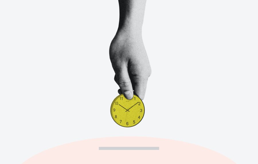 A hand holding a yellow clockMorgan Housel X Fbh4utwk4 Unsplash