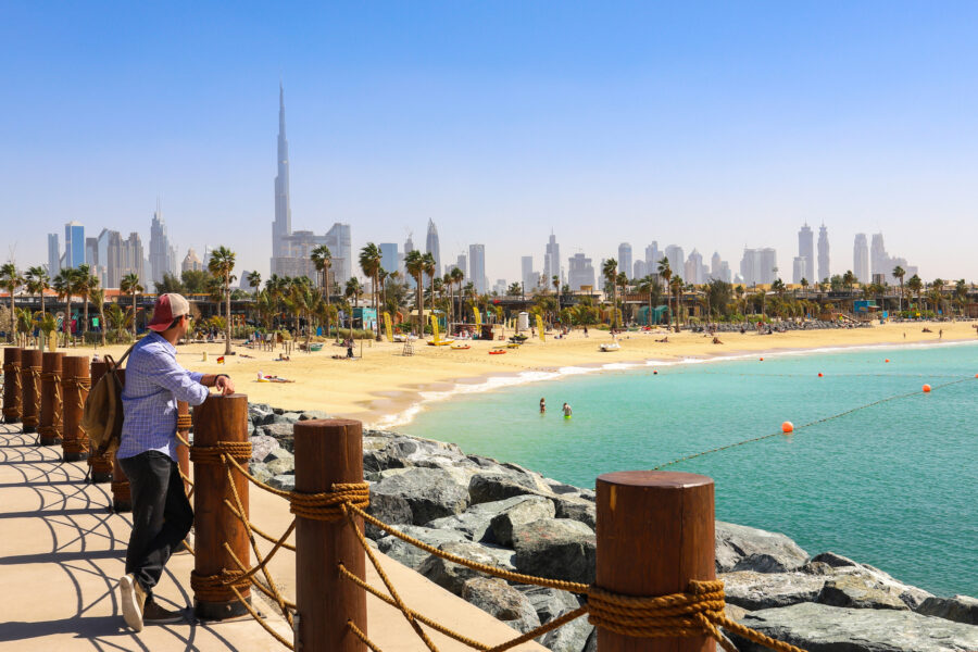 Dubai Beach La Mer, People Rest, In The Distance The Skyscrapers Of The City.