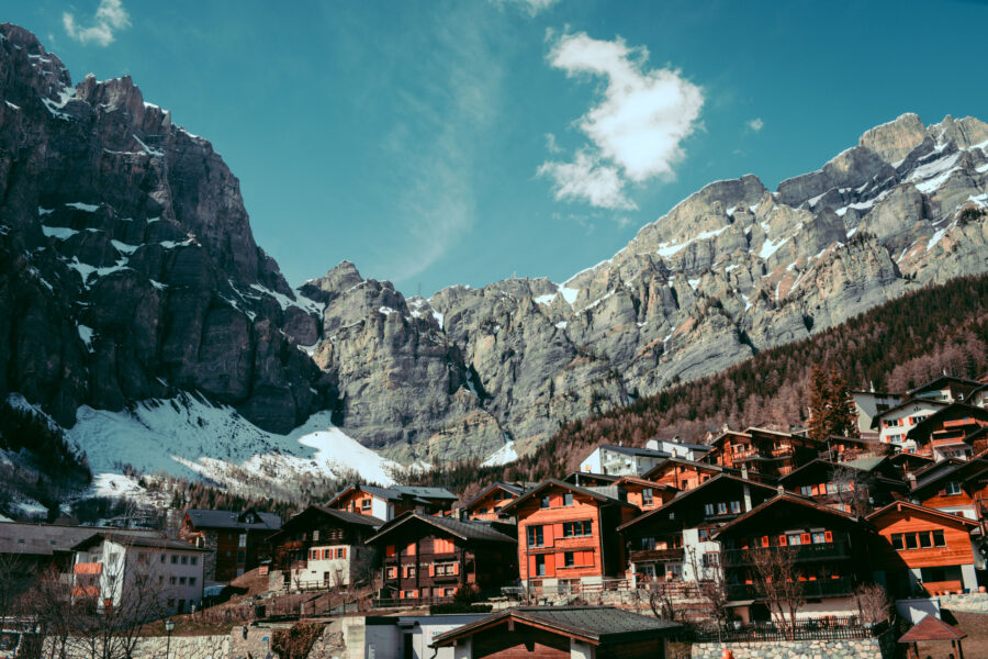 Scenery Of Houses Under Snowy Rocks In Leukerbad, Switzerland