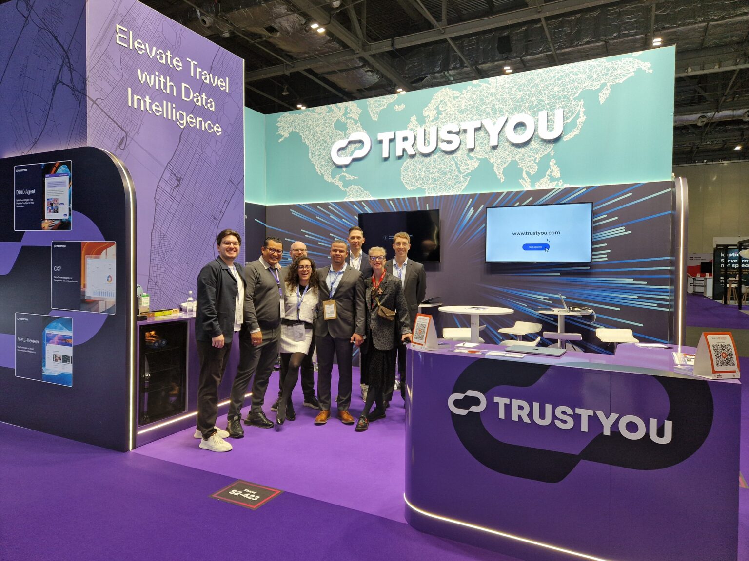 The TrustYou team in front of their WTM booth